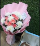 Blushing pink chrysanthemums arranged in a bouquet that speaks of admiration, joy, and gentle beauty.