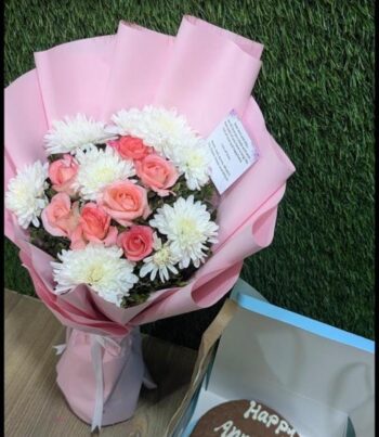 Blushing pink chrysanthemums arranged in a bouquet that speaks of admiration, joy, and gentle beauty.